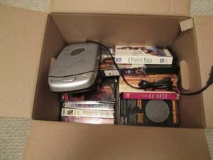 Box of VHS tapes and a VHS tape rew...
