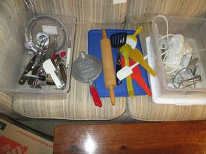 two plastic bins full of various ki...