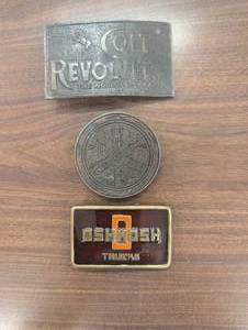 lot 25 image: 3 Brass Belt Buckles - Colt Revolvers, Oshkosh Trucks, Unknown