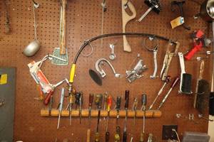 lot 595 image: Contents on Peg Board - Assorted Hand Tools - Screwdrivers, Clamps, Filter Wrench, Hack Saw, Brushes