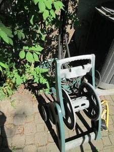 lot 98 image: Mobile hose reel and garden hose wi...