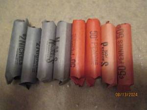 lot 476 image: 4 rolls of nickels and 4 rolls of pennies. Unsearched