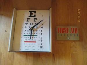 lot 12 image: Eye chart clock and a vintage first...