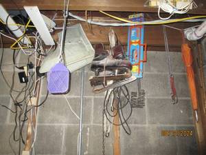 lot 372 image: Contents hanging in utility room. Racquets, ice skates and more