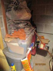 lot 373 image: Corner contents of utility room. Vacuum cleaner, totes of old newspapers