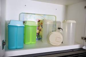lot 47 image: Tupperware Pickle Storage Bins, Cutting Board Etc