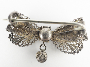 lot 177 image: Vintage (Antique) Hand Made Cannetille  Ribbon Bow With Dangling Cannetille Bead Sterling Silver Brooch .