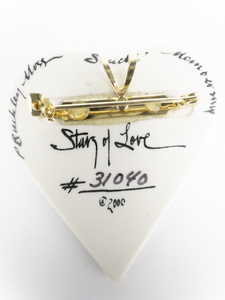 lot 203 image: P. Buckley Moss Membership Society Story Of Love (Serial # 31040), Heart Shape With Picture Of Young Couple. Porcelain brooch With Pendant.