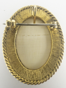 lot 212 image: Peter Driscoll Scrimshaw Picture Of Sailing Ship Yellow Base Metal PinPendant.