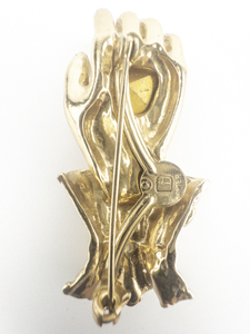 lot 219 image: Napier Open Hand With Large Red Heart Shaped Rhinestone Yellow Base Metal Brooch .