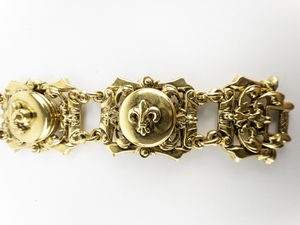 lot 261 image: ArtMode Art Fleur De Lis Yellow Plated Base Metal Panel Bracelet.