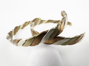lot 265 image: Set of two Tri-Tone Twisted Base Metal Cuff Bracelets.