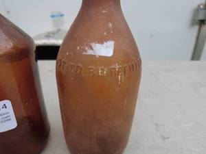 lot 14 image: Lot of 2 Vintage Amber Glass Bottles