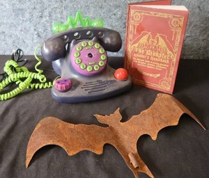 CREEPY PHONE AND HANDBOOK AND A METAL BAT