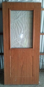 lot 781 image: Wood Grain Slab Door with Glass.