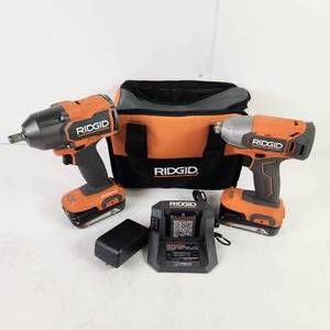 lot 57 image: Two Ridgid Impact Drivers 14 R860021 12 R86012 Two Batteries And Charger