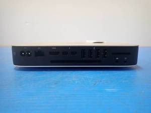 lot 54 image: Apple&nbspMacmini7,1 Mini PC &nbspINTEL CORE I5-4278U 2.6 Ghz  16GB LPDDR3 SDRAM  NO HD  Includes power cable  minor scratches and blemishes on case