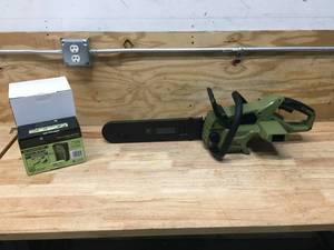 lot 6 image: Green Machine Cordless Chainsaw With 2.5AH Battery And Charger Model # GMCS6200