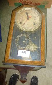 lot 142 image: Antique wind-up clock with time and days