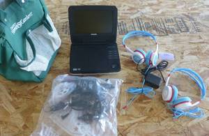 lot 205 image: Small portable vehicle dvd player to keep the kids busy
