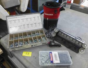 lot 23 image: group of screws, strobe light, Husky bag