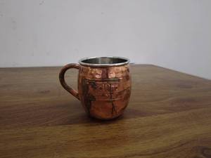lot 271 image: Round Wooden Serving Tray, Copper Mug, and Metal Sign