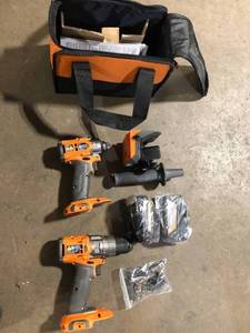 lot 28 image: RIDGID 18V Brushless Cordless 2-Tool Combo Kit with Hammer Drill, Impact Driver, (2) Batteries, Charger, and Bag Customer Returns See Picture