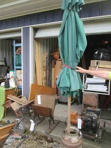 lot 170 image: Patio umbrella with a milk can to hold it