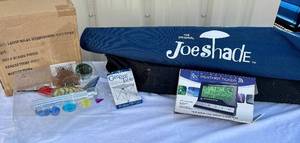 lot 73 image: Outdoor Bundle - Folding Camping Table, Joe Shade Umbrella, Wireless Weather Ticker and Solar Hummingbird Windchime