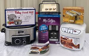 lot 50 image: Mr. Coffee 12 C Programmable Coffee Maker-New In Box , Ninja Cooking System, Marcato Pasta Maker Machine, Foley Food Mill , Cuisipro Mini Roast & Serve and  Oster Homemade Bread Maker- Never Used