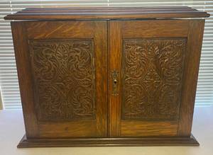 lot 125 image: Antique Oak Carved Pipe Smokers Cabinet with One Medico Imported Briar Pipe & Tom Thumb Smooth Bent Apple Tobacco Pipe, Plus Vintage Medico Filters in Box