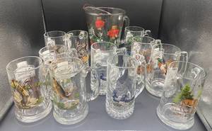 lot 80 image: Set of 11 Schmidt Collector Series Beer Mugs and Glass Pitcher - 2 Bass, 2 Loon, 2 Wolf, 1 Northern Pike, 1 Deer, 1 Mallard, 1 Turkey and 1 Black Bear