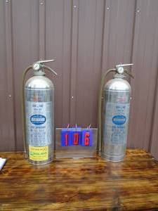 qty of 2 stainless fire extinguisherssquirt guns. As shown.
