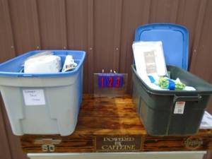 Qty of 2 rubbermaid containers with towels,linens & fridge ice cube maker & etc. As shown.