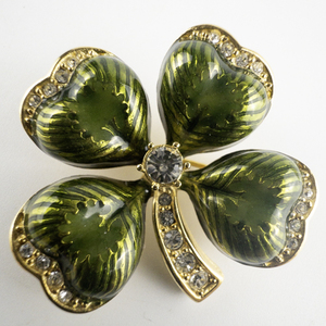 lot 84 image: Joan Rivers Green Enamel Rhinestone Four Leaf Clover Gold Plated Base Metal Brooch .