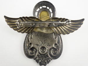 lot 86 image: Two-Tone Pressed Angel Base Metal Brooch .