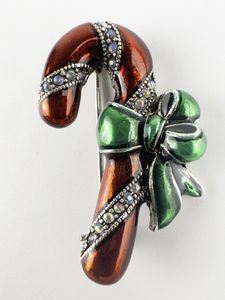 lot 104 image: Enameled Rhinestone Candy Cane Silver Tone Base Metal Brooch .