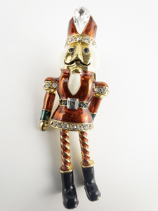 lot 105 image: AVON Christmas Nutcracker Toy Soldier Gold Plated Base Metal Brooch . Legs & Arms Swing