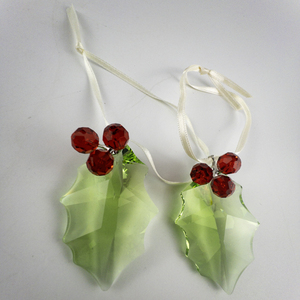 lot 8 image: Swarovski Set of two 200 6 Crystal Holly Leaf Ornament .