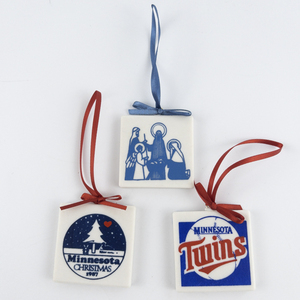lot 133 image: Set of 3 Ceramic Square Christmas Ornaments. MN Twins, MN X-mas 1987 & Nativity.