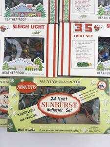 lot 17 image: Vintage Group of 9 Sleigh Lights & Sunburst Lights. 5 Packs working, all in original packaging.