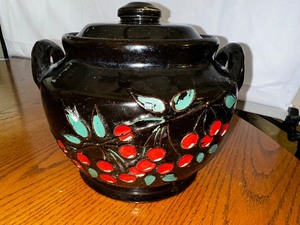 lot 614 image: Vintage 1940s Black with Red Cherries Stoneware Bean Pot with Lid. Estimated Value $75-175