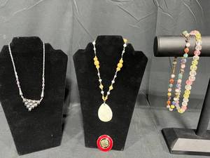 lot 228 image: Assorted Jewelry Lot Necklaces, Bracelets, and Brooches - displays not included