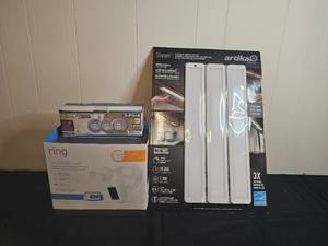 lot 152 image: Ring Floodlight Cam, Patriot Lighting LED Puck Lights, and Artika LED Under Cabinet Light Kit