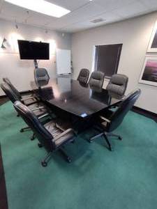 lot 1 image: Conference Table with 8 adjustable executive arm chairs on wheels