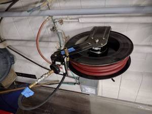 lot 115 image: Self-retracting Storing Air Hose Reel with hose.