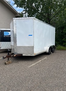 lot 7 image: 2016 Cross 7 x 14 V-nosed dual axle Enclosed Cargo Trailer. Side door and rear ramp door.