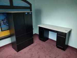 lot 46A image: Blackgray desk with 2-drawer pedestal and storage pedestal Corian surface. Tall black and gray cabinet