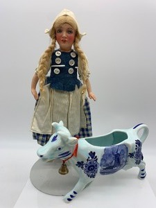 lot 117 image: Vintage 1960s DUTCH DELFT BLUE Ceramic Cow Creamer with a GERMAN BISQUE Dutch Doll