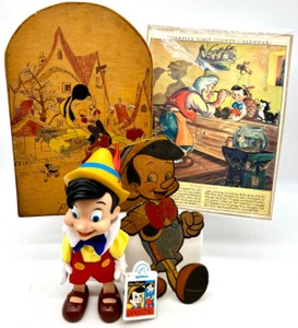 lot 256 image: Vintage MORRELLS WALT DISNEY PINOCCHIO Calendar, Artist Signed PINOCCHIO CARVING, PINOCCHIO Figure and Cardboard Cut Out